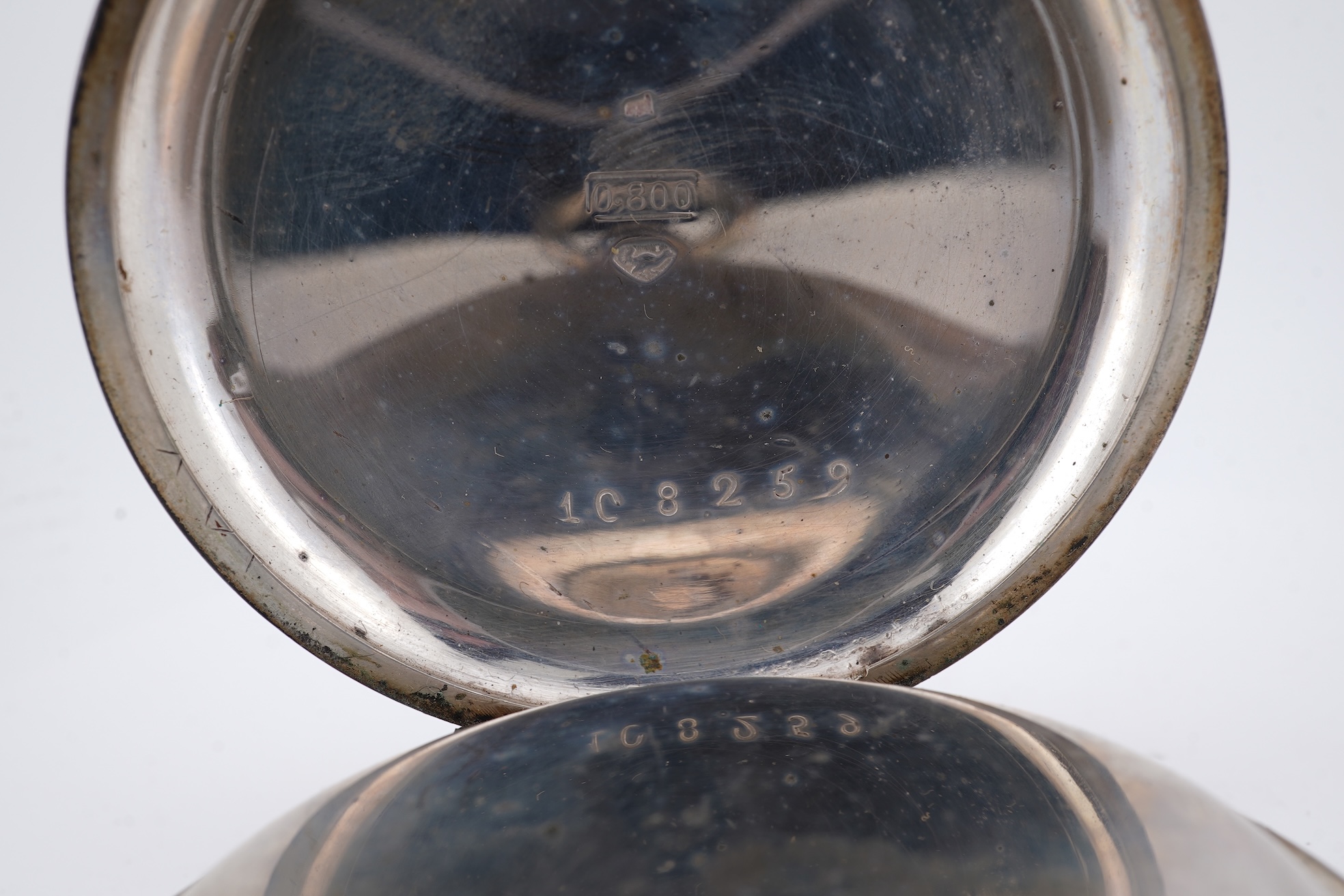 An early 20th century continental 800 standard white metal open faced chronograph pocket watch, with Roman numerals and two subsidiary dials, case diameter 50mm, together with a similar smaller white metal open faced poc
